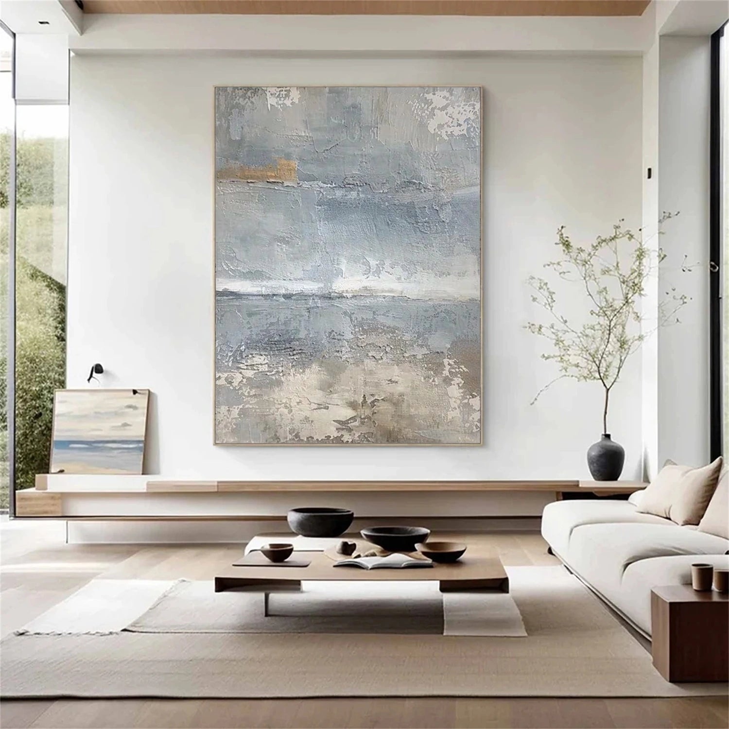 A textured blue painting with raised strokes catching light