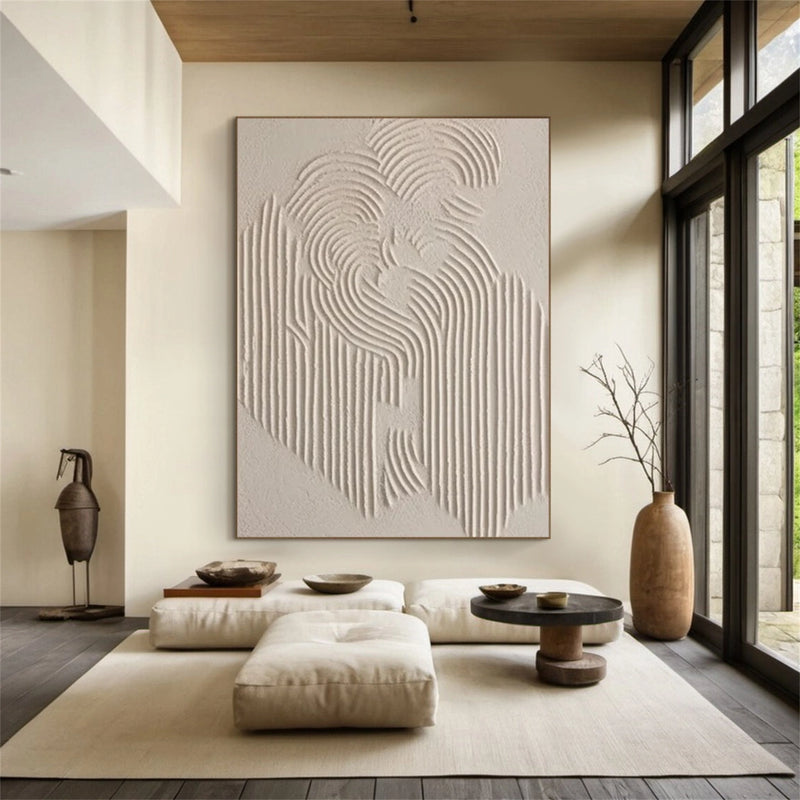 A framed hand-painted textured canvas in warm beige and brown tones, shown in a living room setting